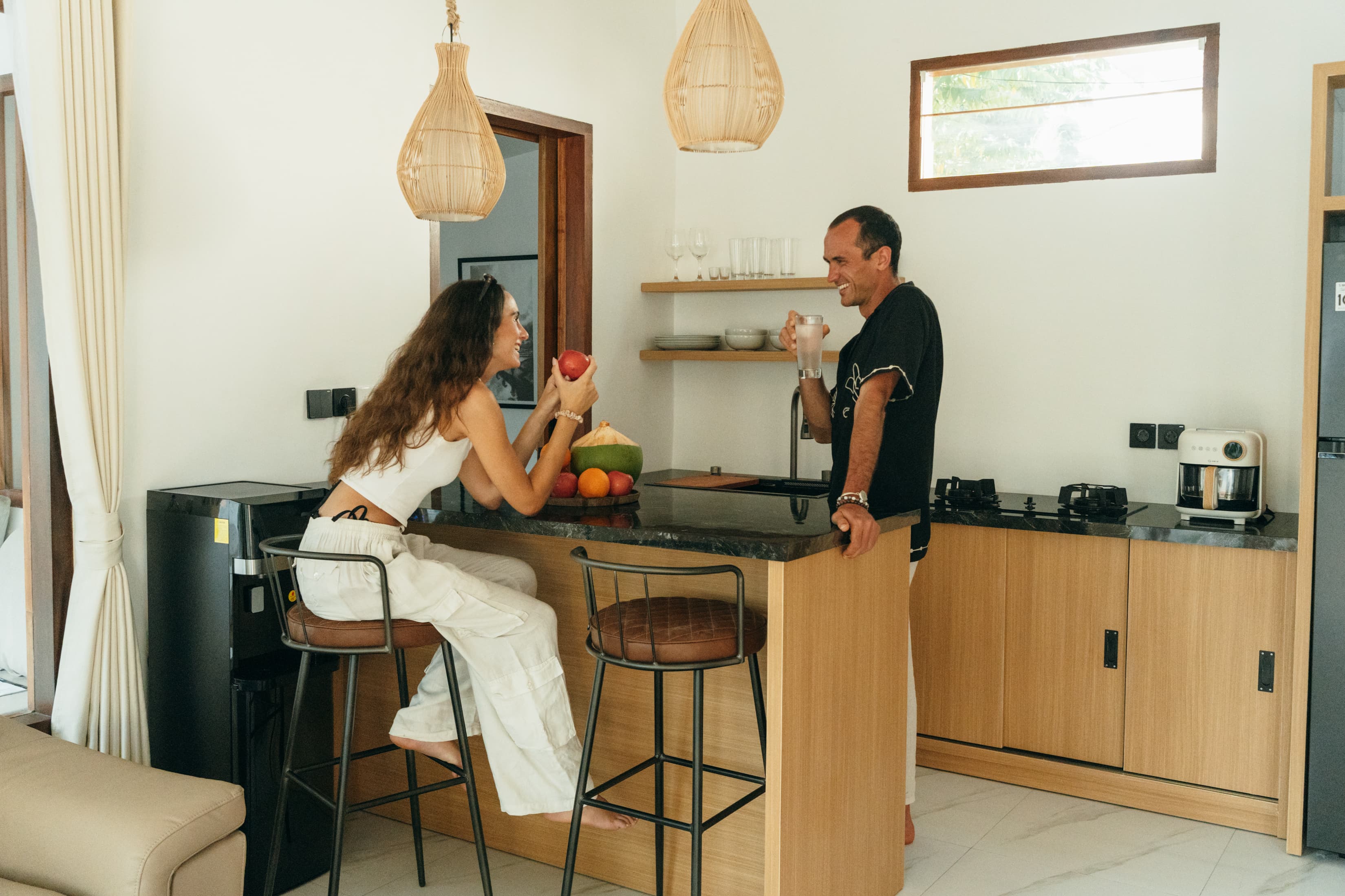 Couple having breakfast at kitchen island