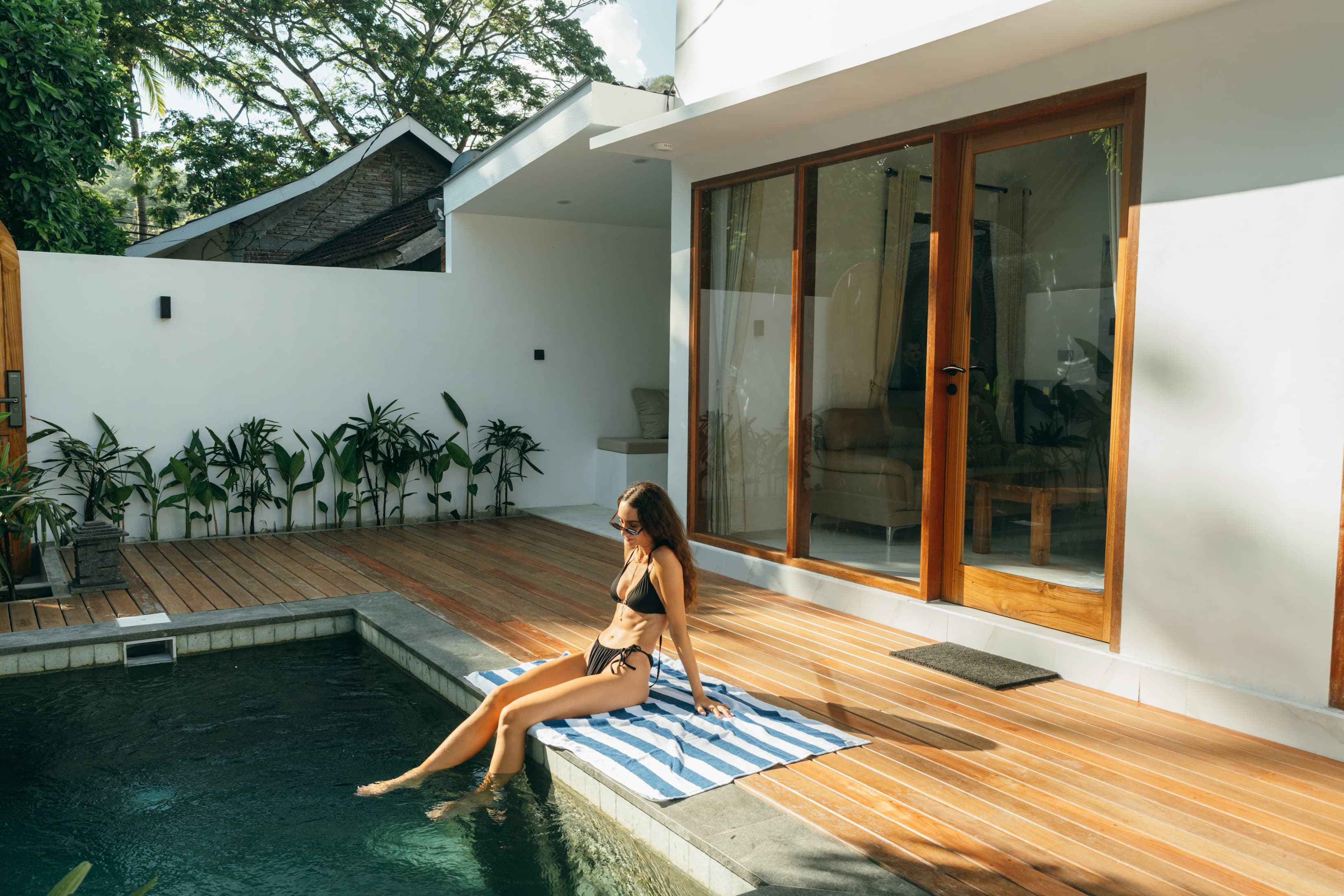 Woman relaxing by the private pool